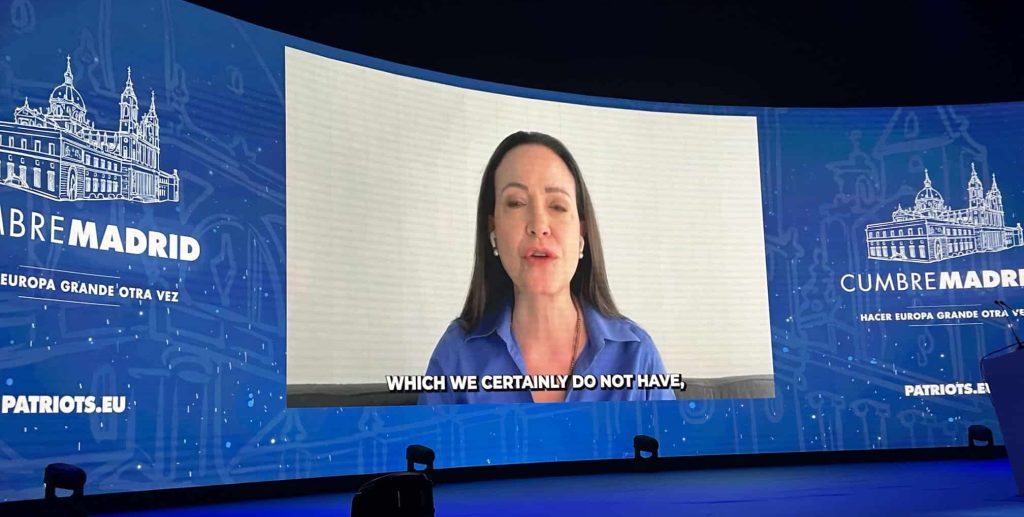 Maria Corina Machado addresses the far-right Patriots for Europe conference flanked by 'Make Europe Great Again' slogans (photo: Mike Gonzalez/X)