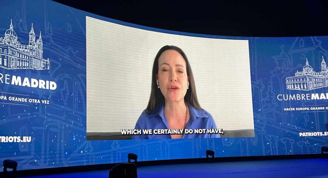 Maria Corina Machado addresses the far-right Patriots for Europe conference flanked by 'Make Europe Great Again' slogans (photo: Mike Gonzalez/X)