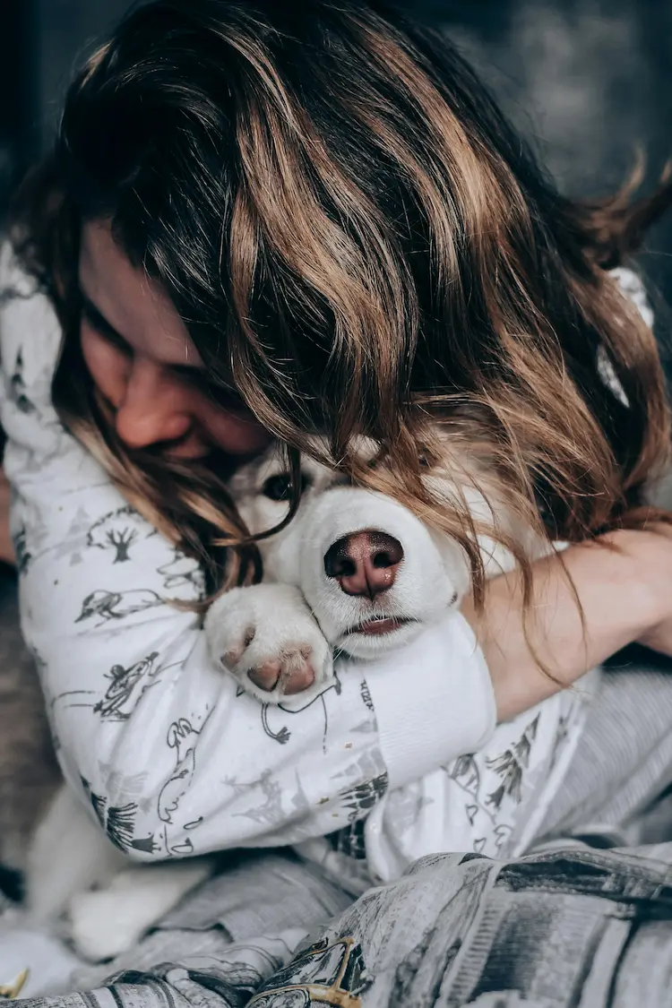 A woman hugging a husky