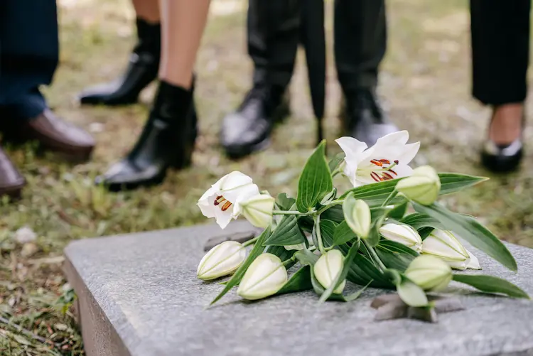 White lilies on a tombstone.