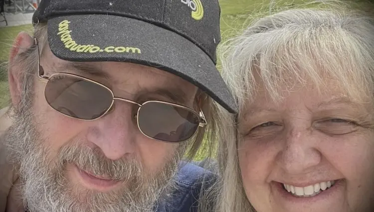An older looking couple, taking a selfie.