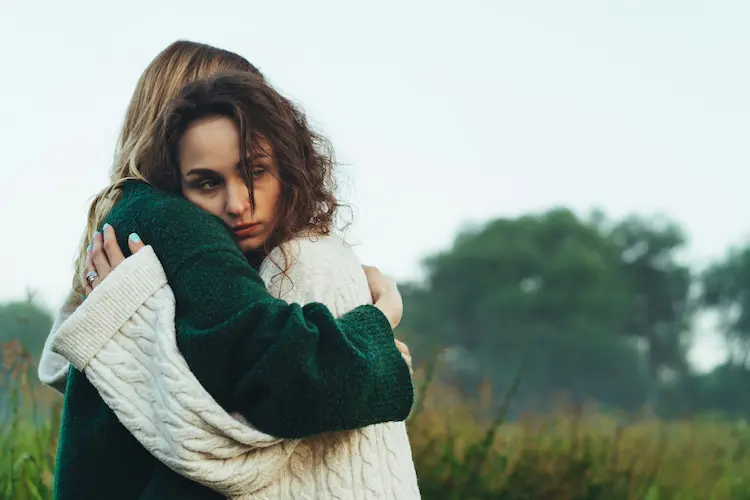 Two girls hugging.