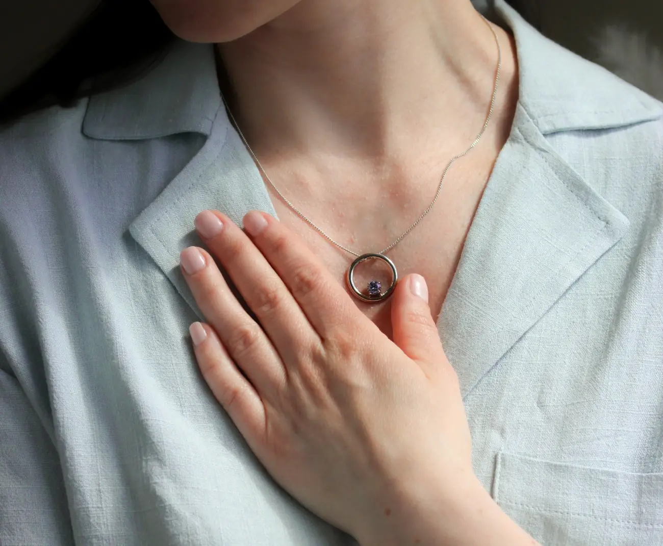 A woman wearing memorial pendant