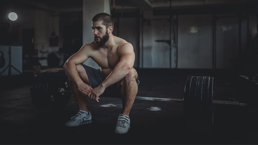 A weightlifter observes a rest period after an exercise.