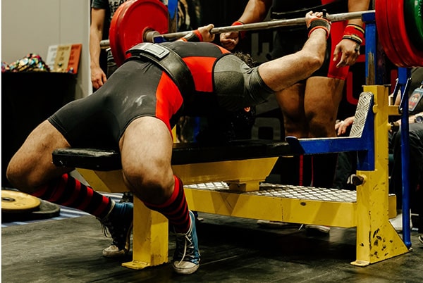 A powerlifter does a bench press with a barbell.