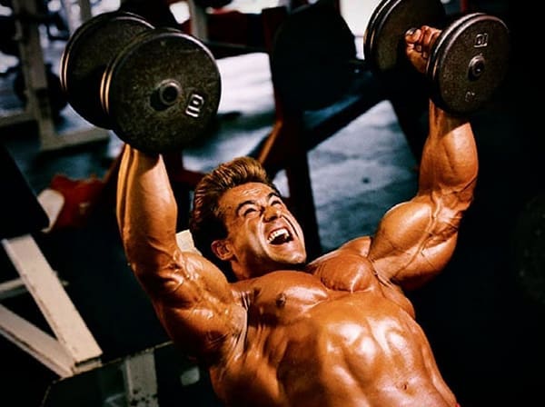 Francis Benfatto performs a weight training exercise with dumbbells.