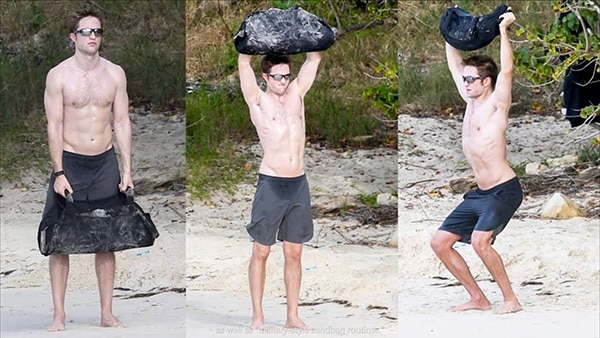 Robert Pattinson trains shirtless in the sand.