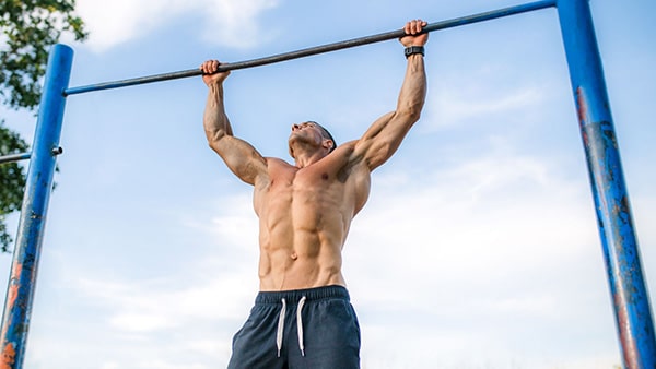 A man performs pull-ups to prepare for the Army physical test.