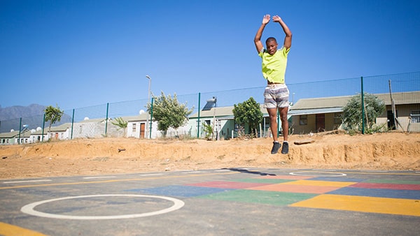 A man jumping while performing the burpee exercise.