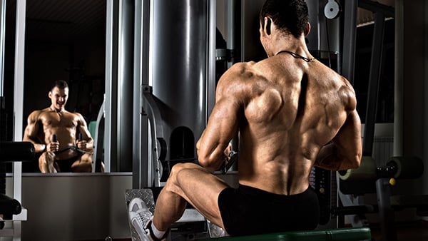 A weightlifter is doing a horizontal pull.