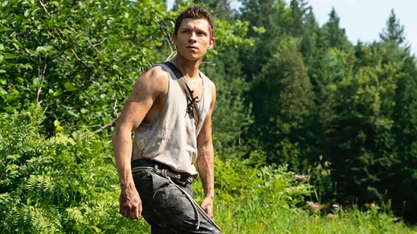 Tom Holland in a tank top as Nathan Drake in the movie Uncharted.