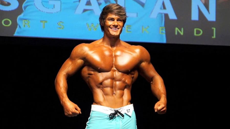 Jeff Seid shirtless posing on the stage of a professional bodybuilding contest.