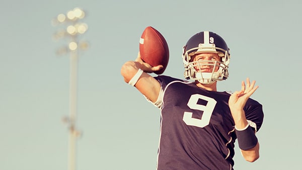 An American soccer player throws the ball.