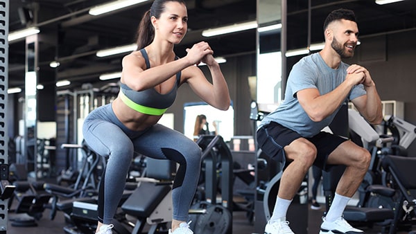 A woman and a man are doing physical activity in a gym to lose weight.