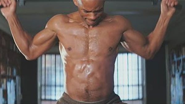 An excerpt from the film I Am Legend shows Will Smith shirtless, abs showing, doing pull-ups.