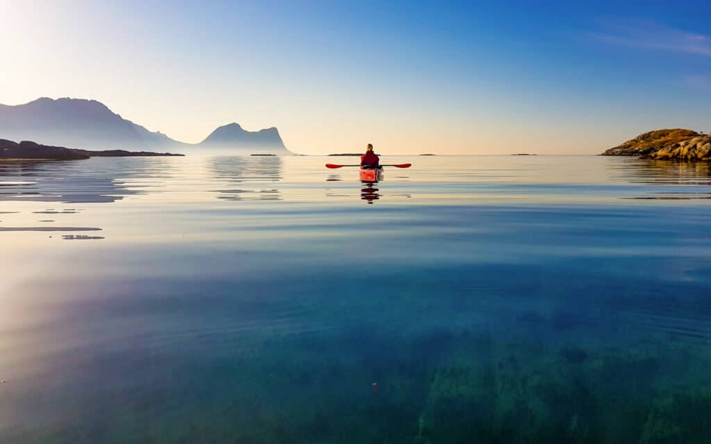 sea kayaker in between the islands of Bergsfjord in Senja Norway