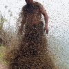 This picture taken on April 9, 2014 shows She Ping, a 34 year-old  local beekeeper, covered with a swarm of bees on a small hill in southwest China's Chongqing. She Ping released more than 460,000 bees, attracted them to his body,  and made himself a suit of bees that weighs 45.65kg within 40 minutes, local newspaper reported.AFP PHOTO CHINA OUTSTR/AFP/Getty Images