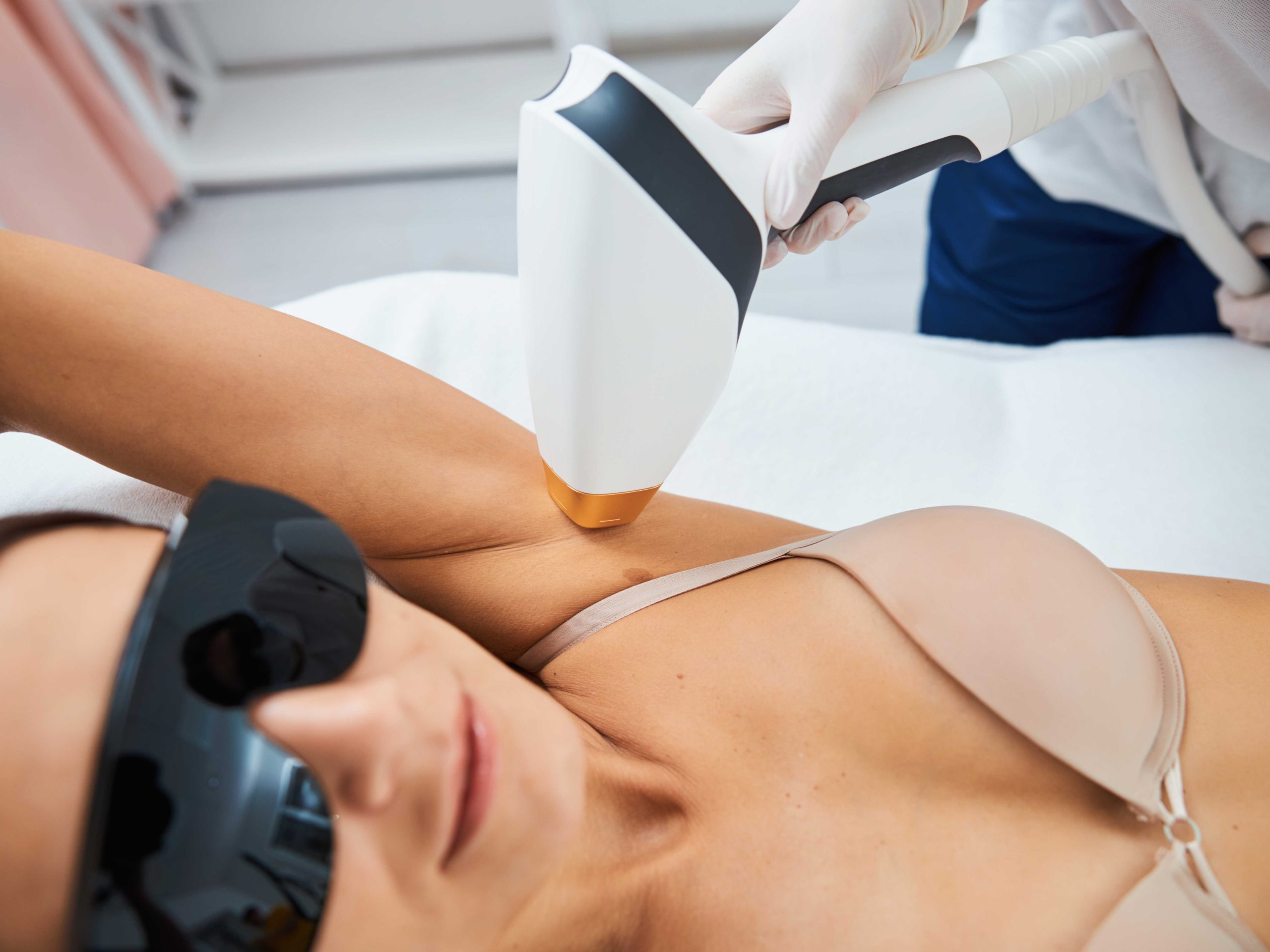 Serene client undergoing an underarm laser hair removal