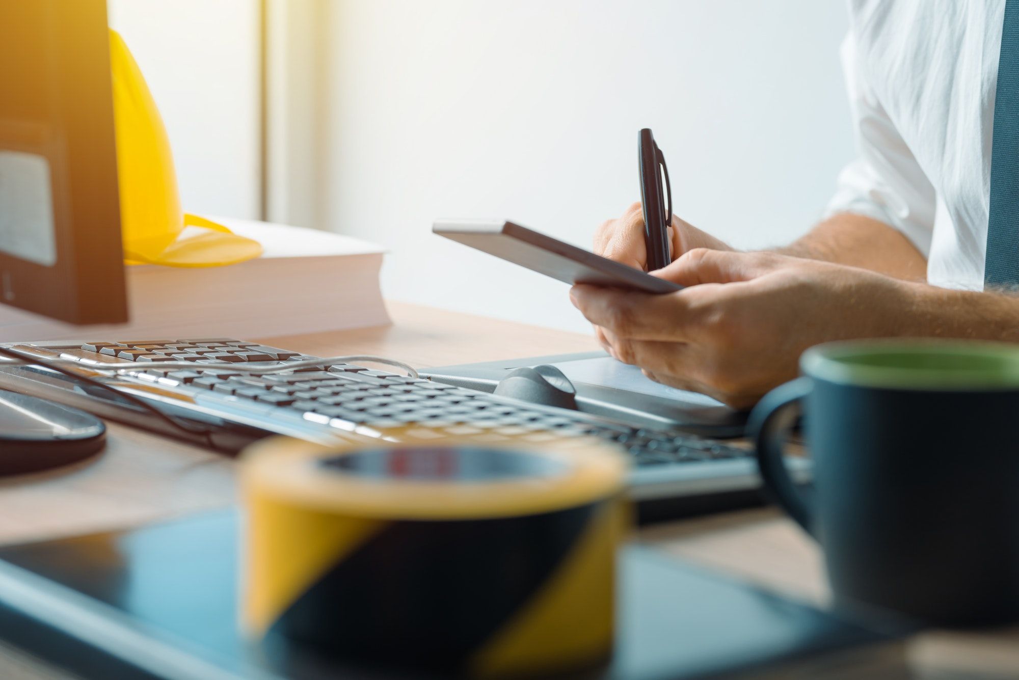 Civil engineer using smartphone in office