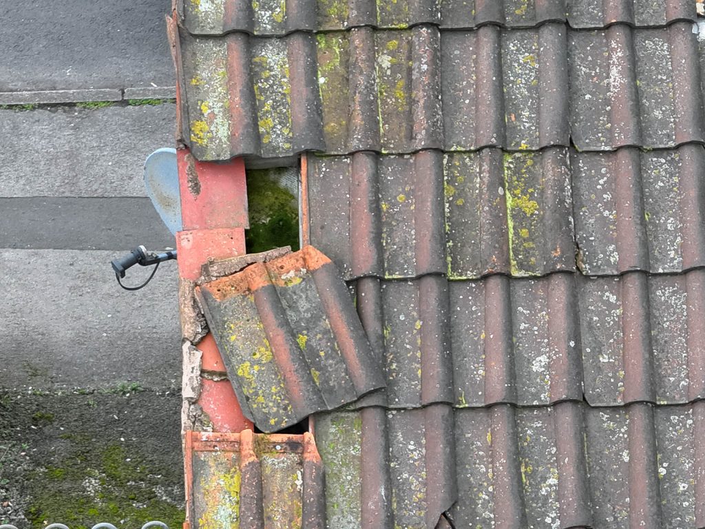 Close-up of a damaged clay roof tile identified during a Sky Sight aerial inspection
