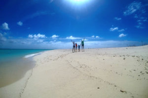 family on the desert island beach