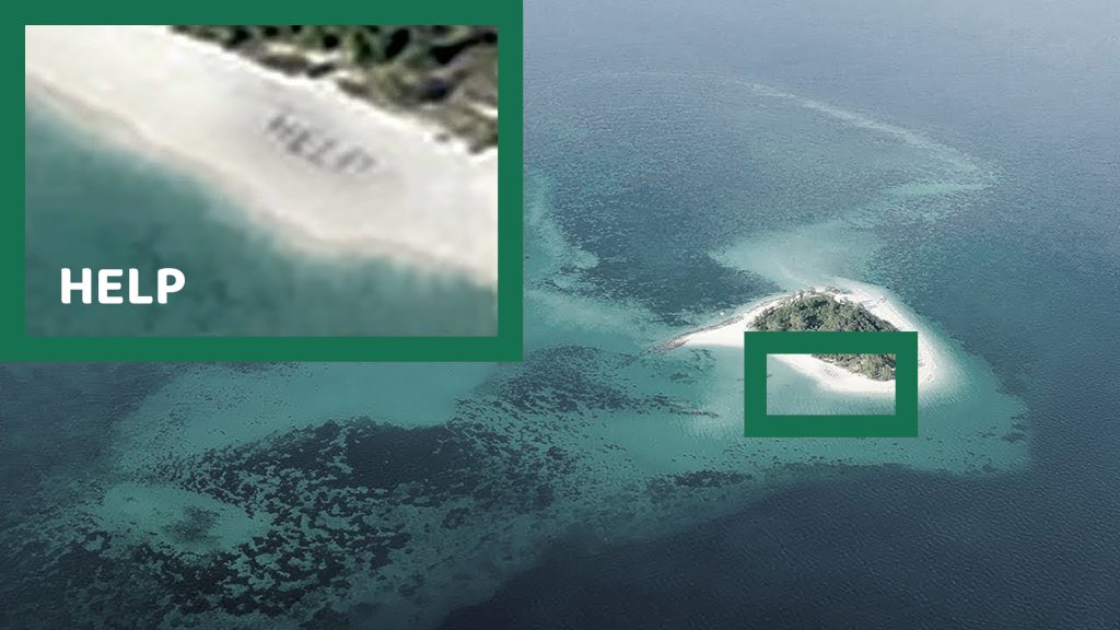 Help sign on a small desert island beach from above