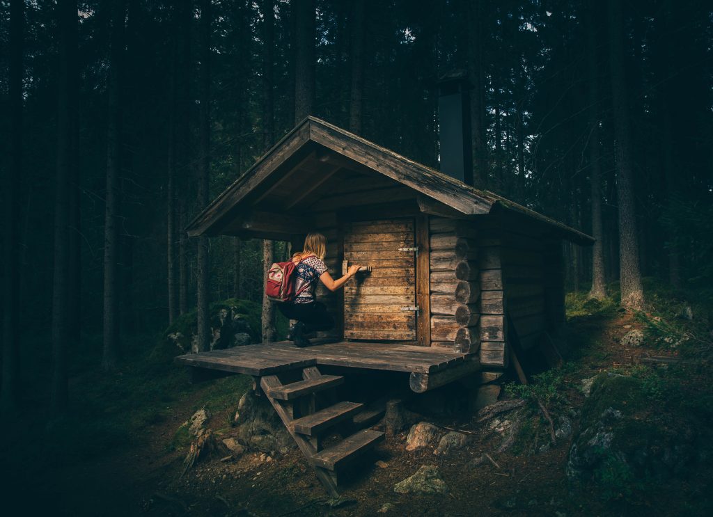 A hermit's simple wooden hut in the woods