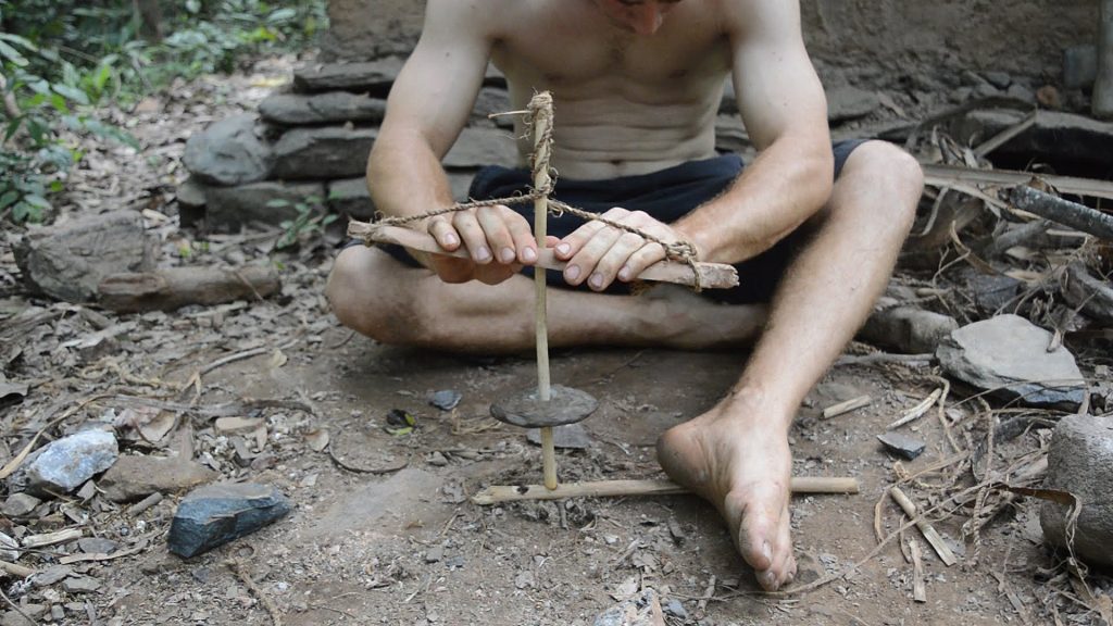 Igniting a fire from friction on a survival trip