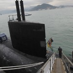 Sailors stand on board at the Los Angeles-class, fast attack submerine USS Hampton in Hong Kong waters