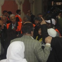 Arab League observers talk to people during a visit to Zabadani