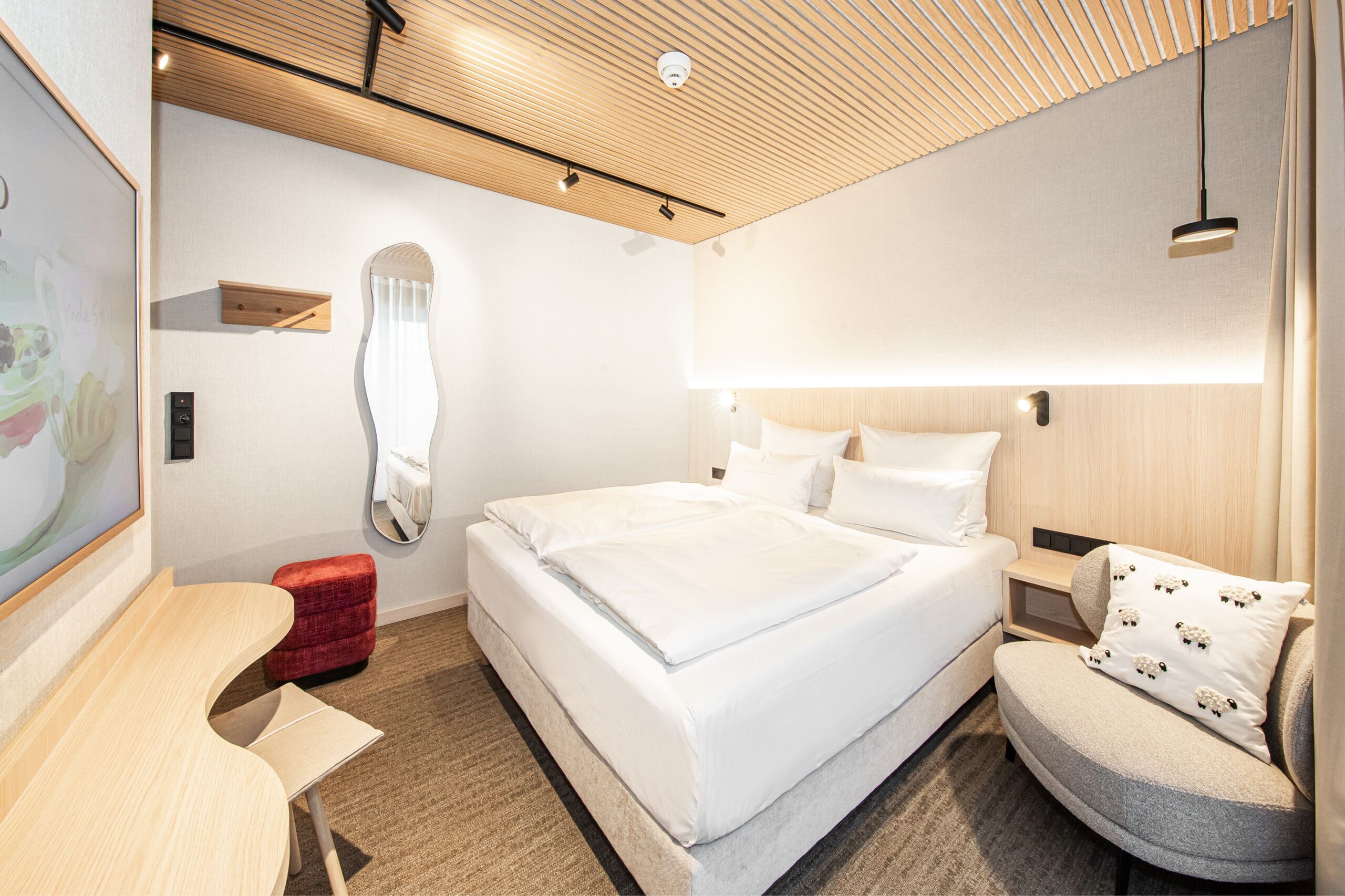 Hotellrum i skandinavisk stil, akustikpanel i ljust trä, dubbelrum