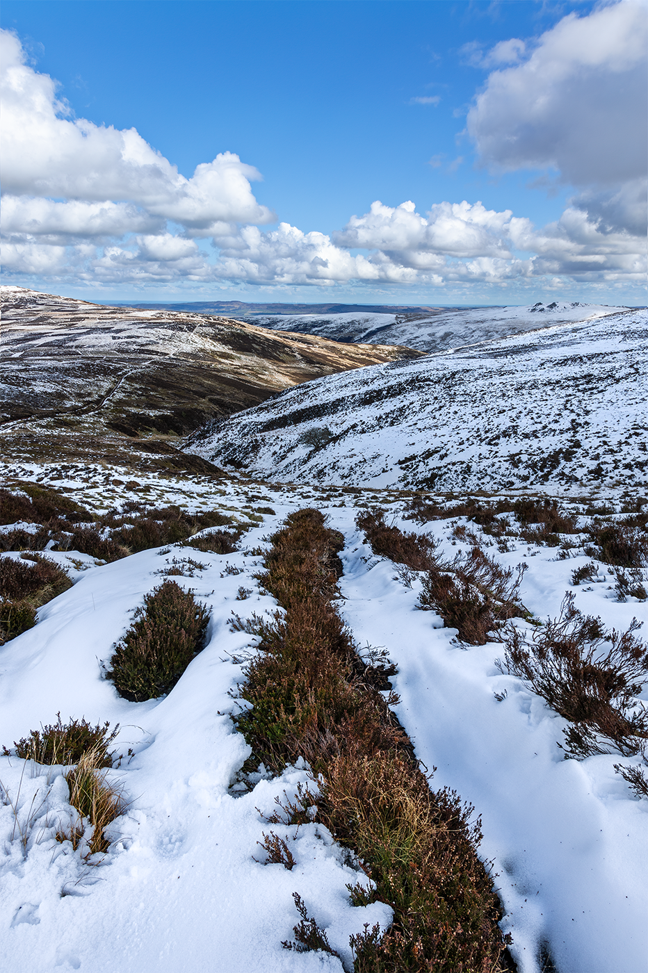 Late Spring snowfall begins to melt on the slopes of the Cheviot Hills