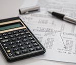 Close-up of financial documents with calculator and pen, ideal for business management themes.