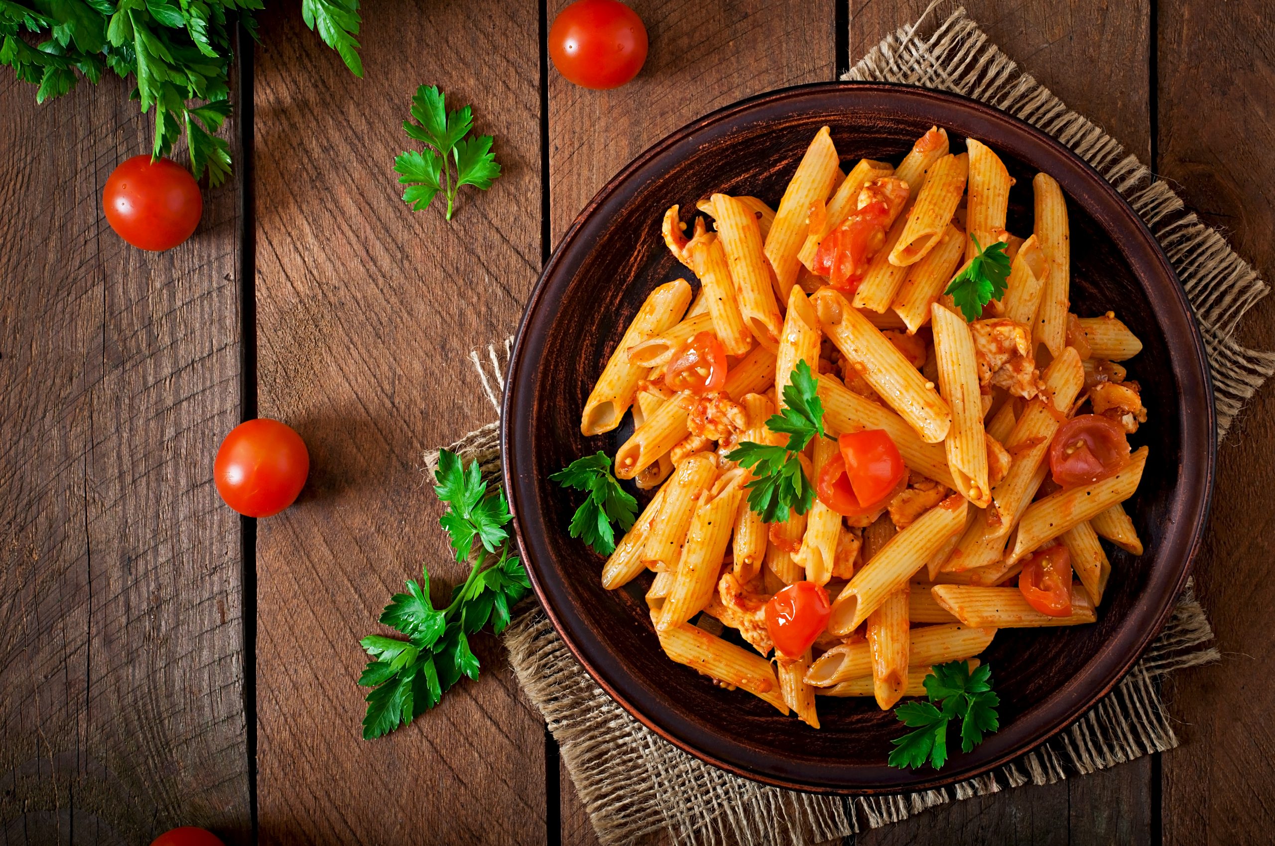 penne pasta tomato sauce with chicken tomatoes wooden table scaled