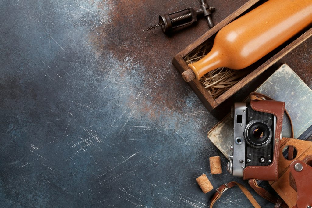 Wine bottle in box and vintage camera