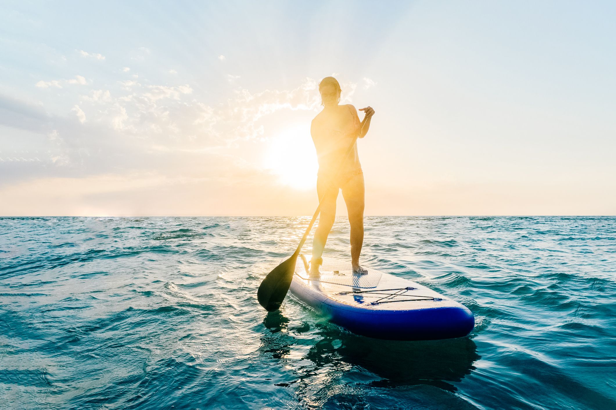 woman-stands-on-a-paddle-board-in-the-sea-during-royalty-free-image-1687470969