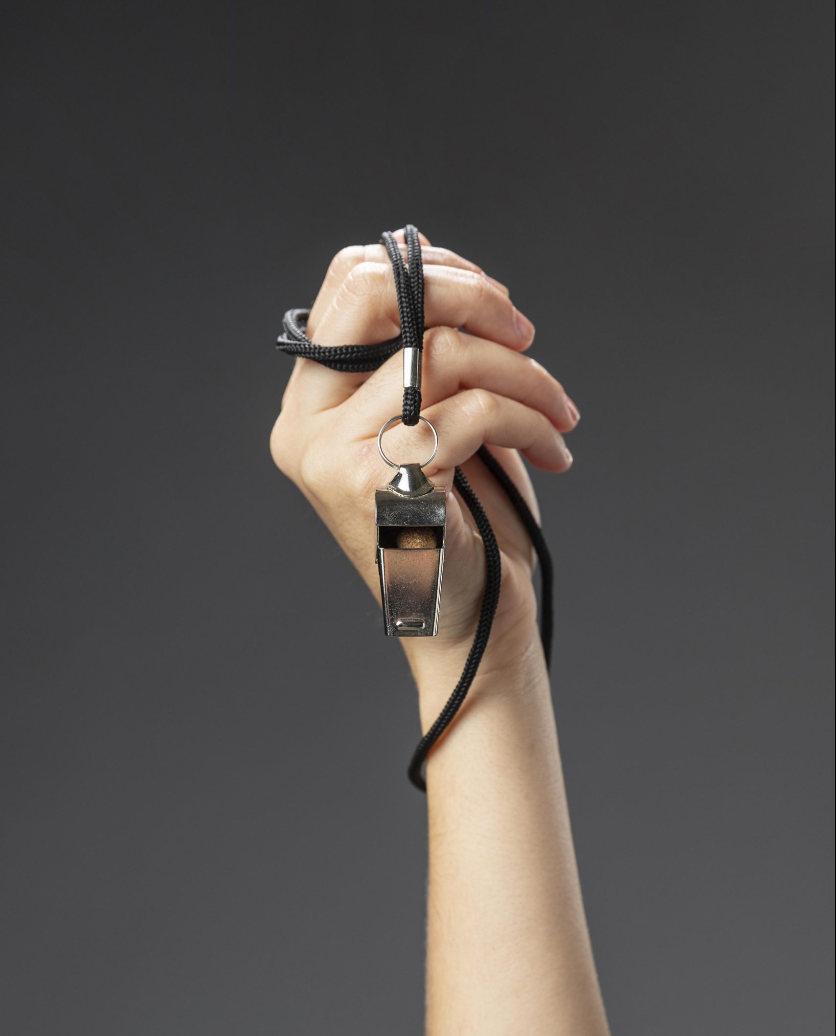 female-referee-hand-with-whistle-close-up