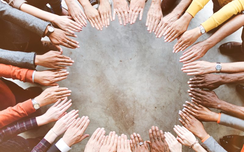 aerial-view-supported-hands-out-together