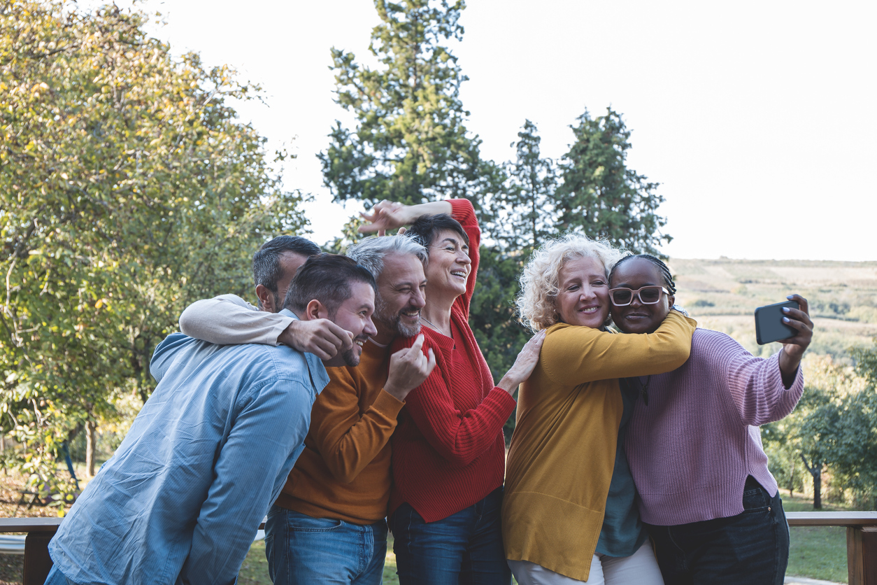 Happy diverse friends making selfie outdoors