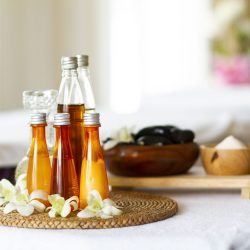 Spa accessories for massage healthy Spa accessories wellness setting with cosmetic bottles and salt with orchid, blurred massage stones in wooden bowl, spa concept, copy space