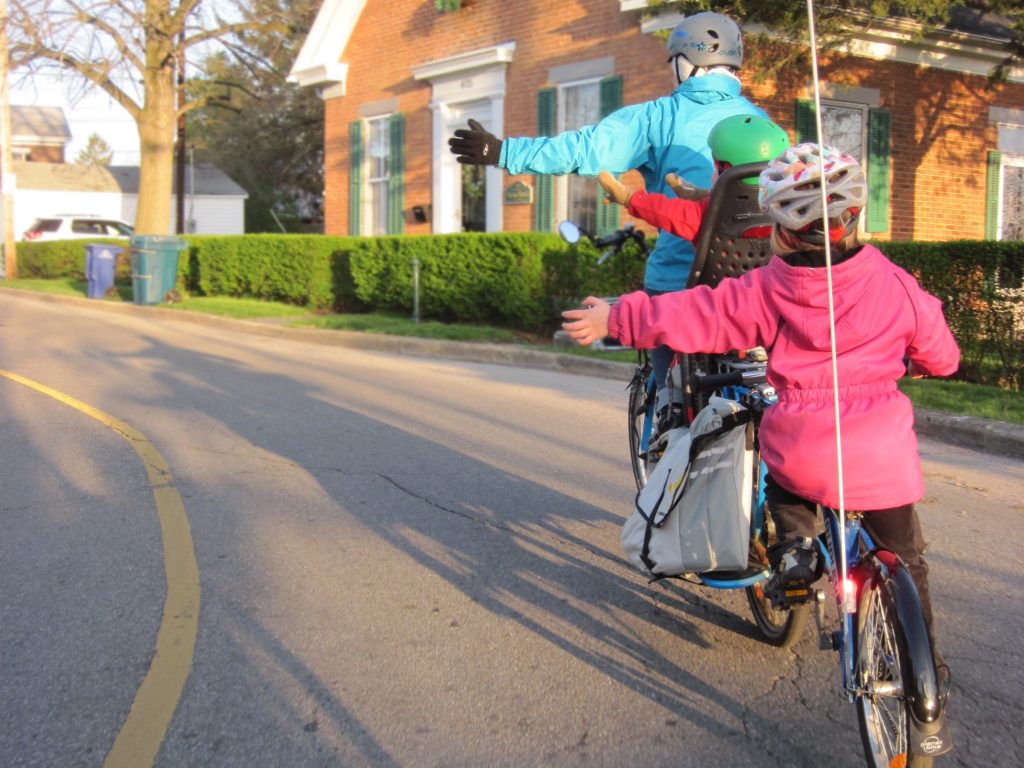 a family cycling on the road