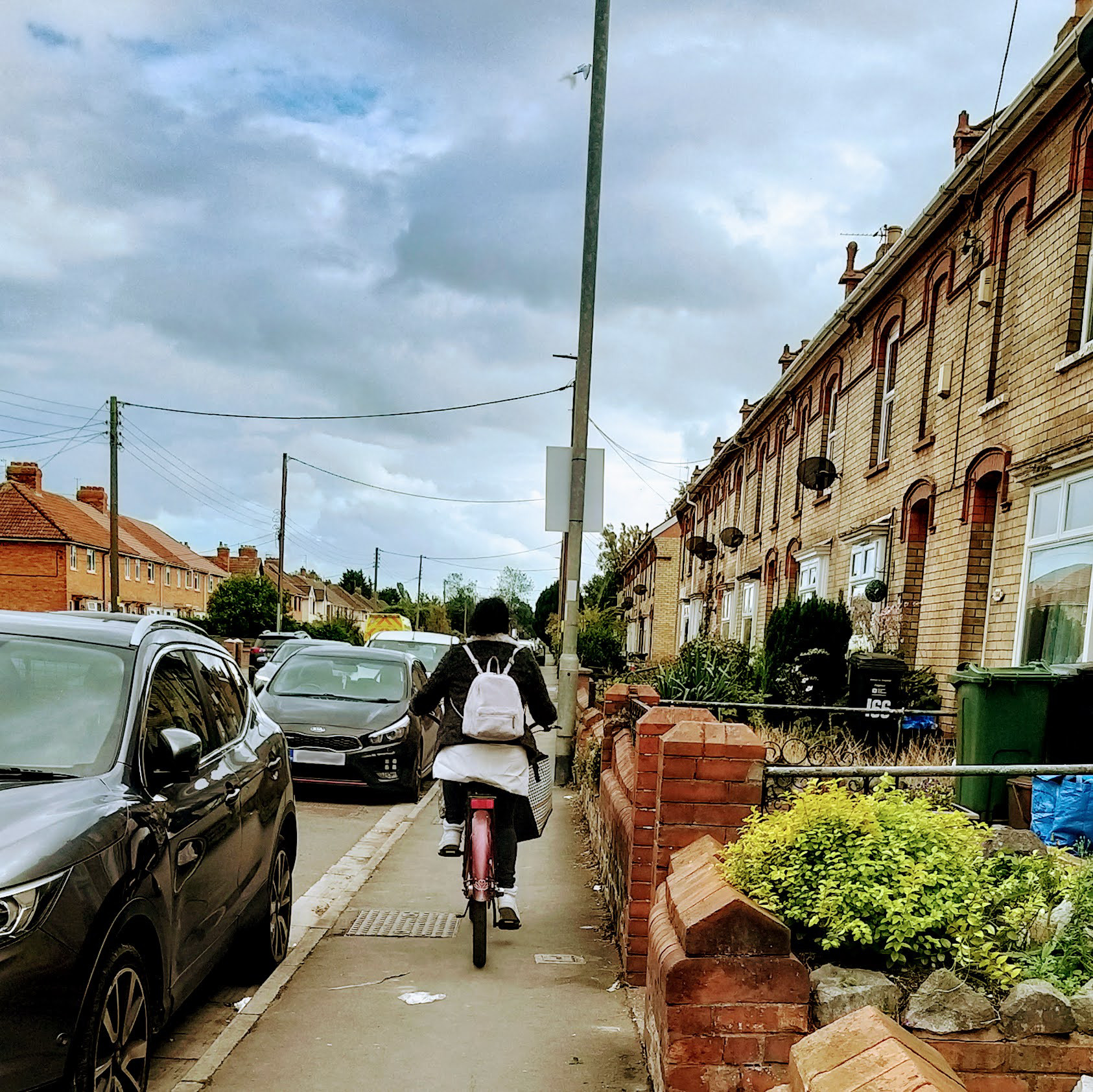 woman cycling on pavement