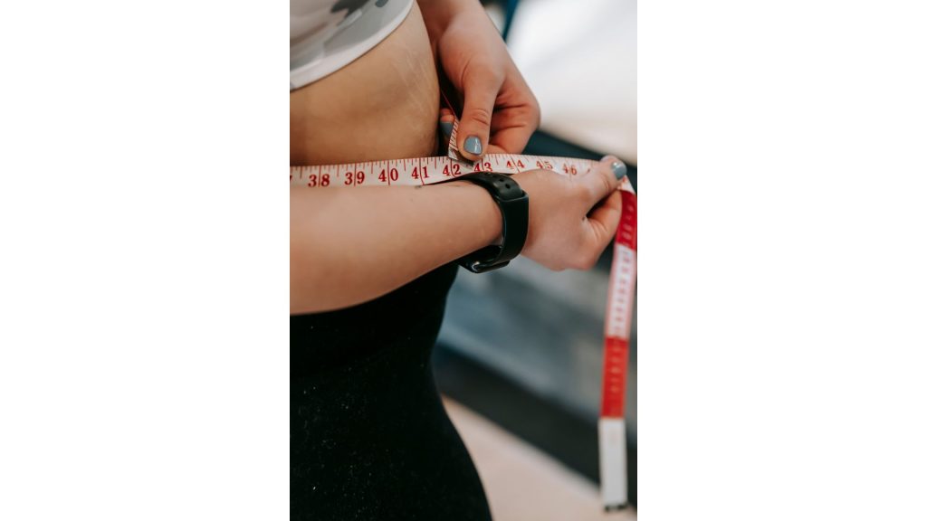 woman measuring waist circumference