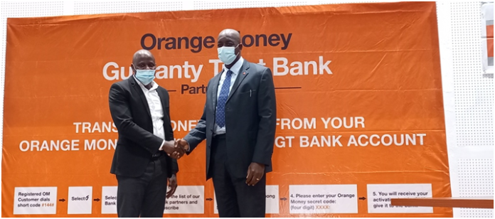 Orangemoney CEO, David Mansaray with GTBank’s Managing Director, Ade Adebiyi…celebrating the partnership