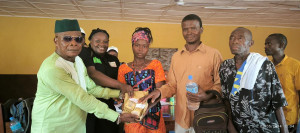 Regent Chief of Bari Chiefdom- (Left) hands over cash to project participants in Potoru Community