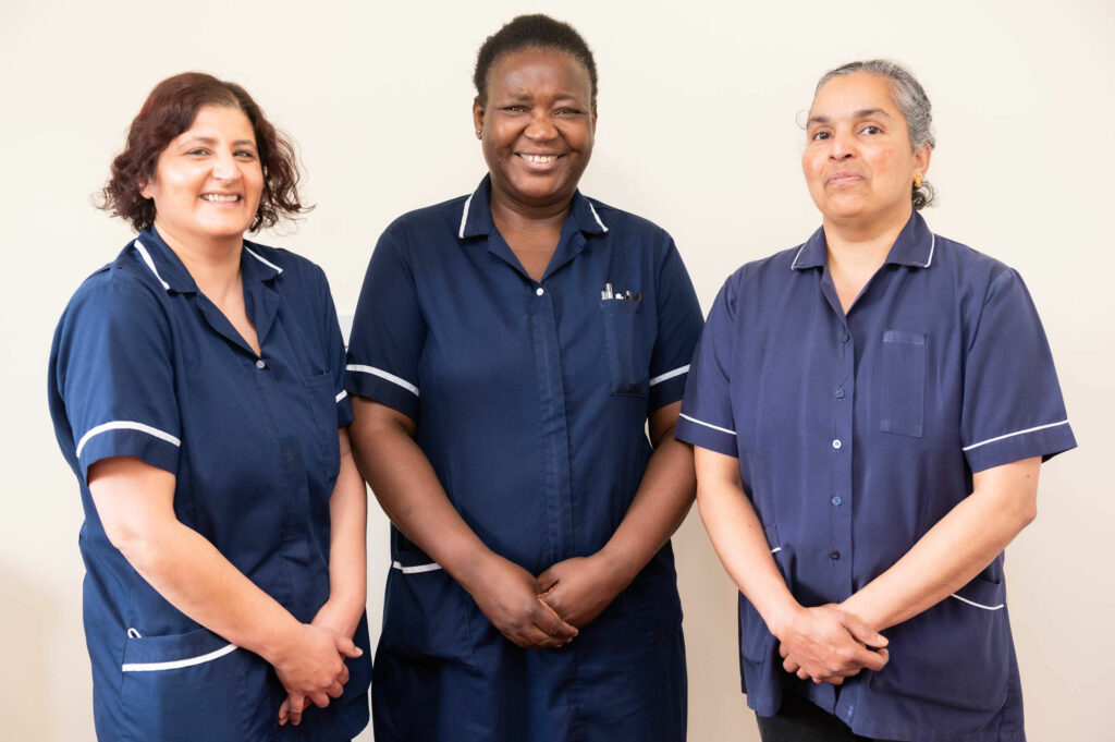 3 members of staff smiling.