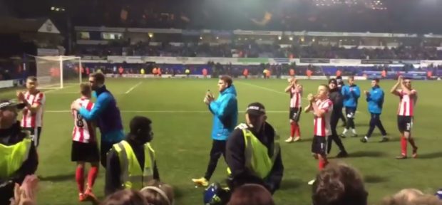 The Lincoln City players enjoy the moment with their fans at the end of the match (Photo: James Williams)