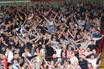 Lincoln City supporters in full voice at the LNER Stadium. 