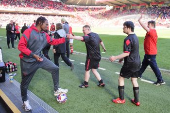 Zane Okoro of Lincoln City with Lincoln City Foundation's DS Active football team during the EFL Sky Bet League One match between Charlton Athletic and Lincoln City at The Valley, Charlton.Picture: Chris Vaughan Photography for Lincoln City FC Date: April 5, 2025