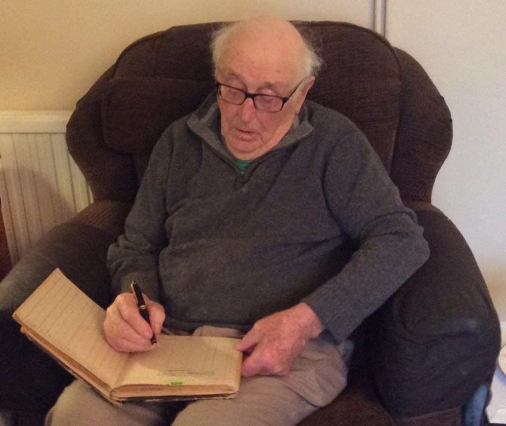 Victor Gregg signing The Log Book